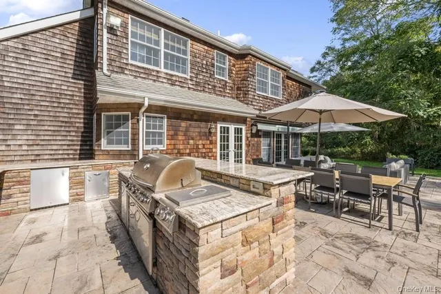 a view of a patio with furniture and a garden