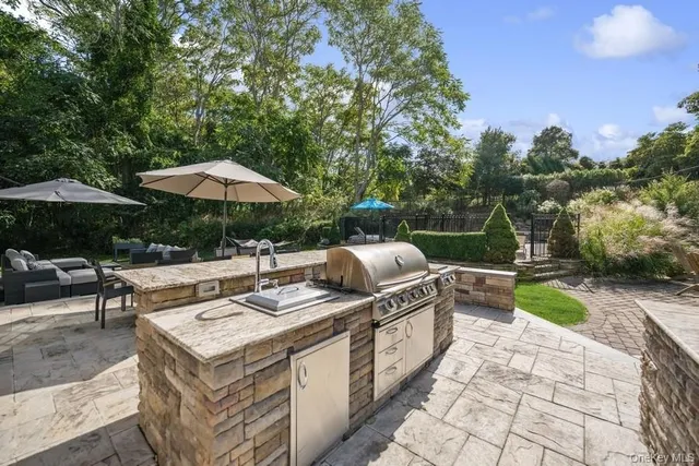 a view of table and chairs under an umbrella