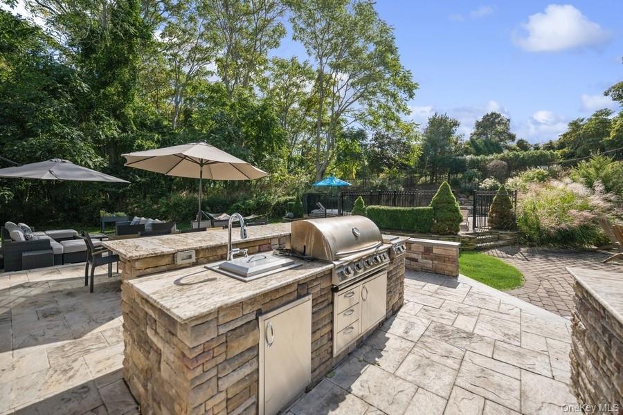 39 Smugglers Path Riverhead, NY 11901 - Photo 37 of 47 a view of a patio with furniture and a garden