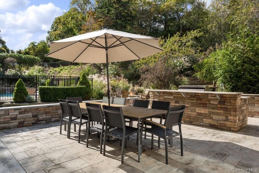 39 Smugglers Path Riverhead, NY 11901 - Photo 38 of 47 a view of table and chairs under an umbrella