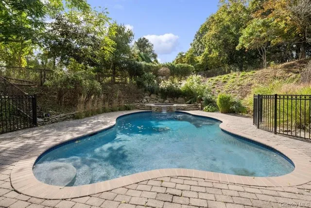 a view of backyard with a table and chairs and potted plants