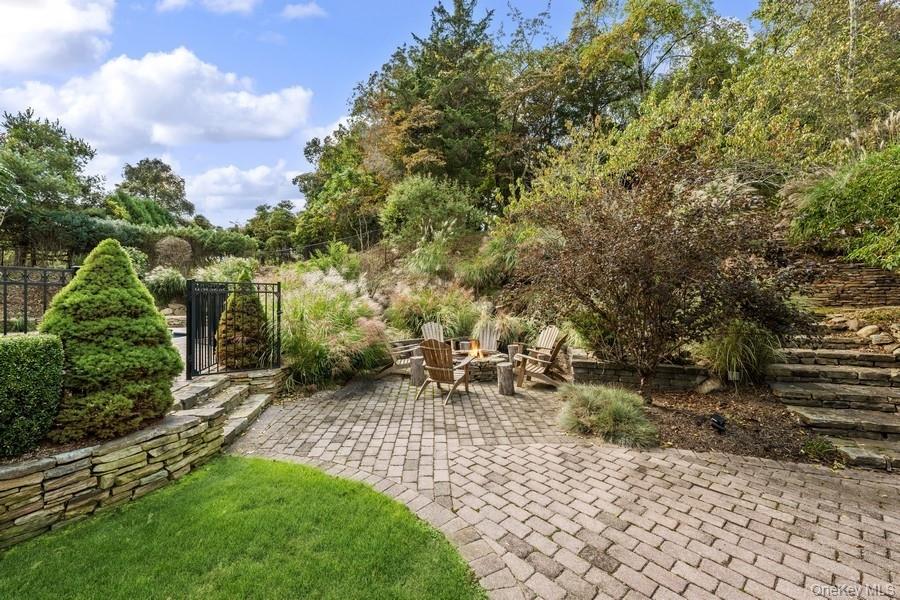 39 Smugglers Path Riverhead, NY 11901 - Photo 44 of 47 a view of backyard with a table and chairs and potted plants