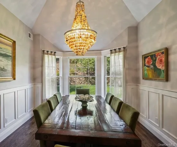 a view of a dining room with furniture wooden floor and chandelier