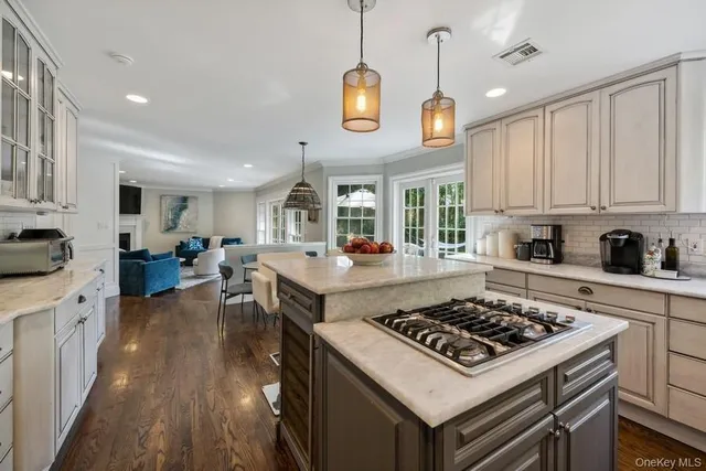 a kitchen with stove and wooden floor
