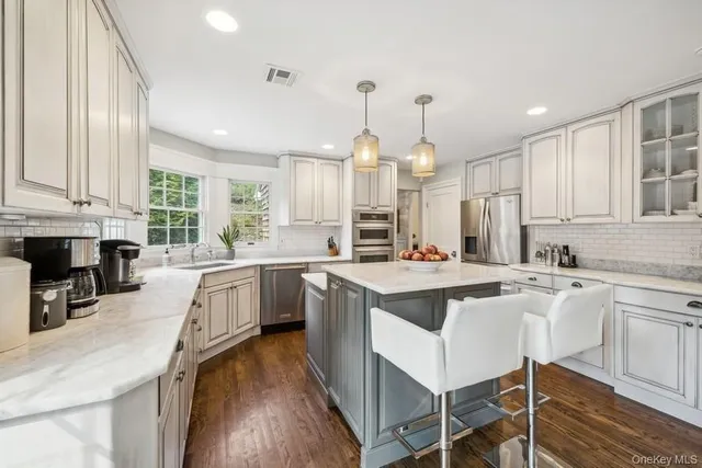 a kitchen with counter top space a sink appliances and cabinets