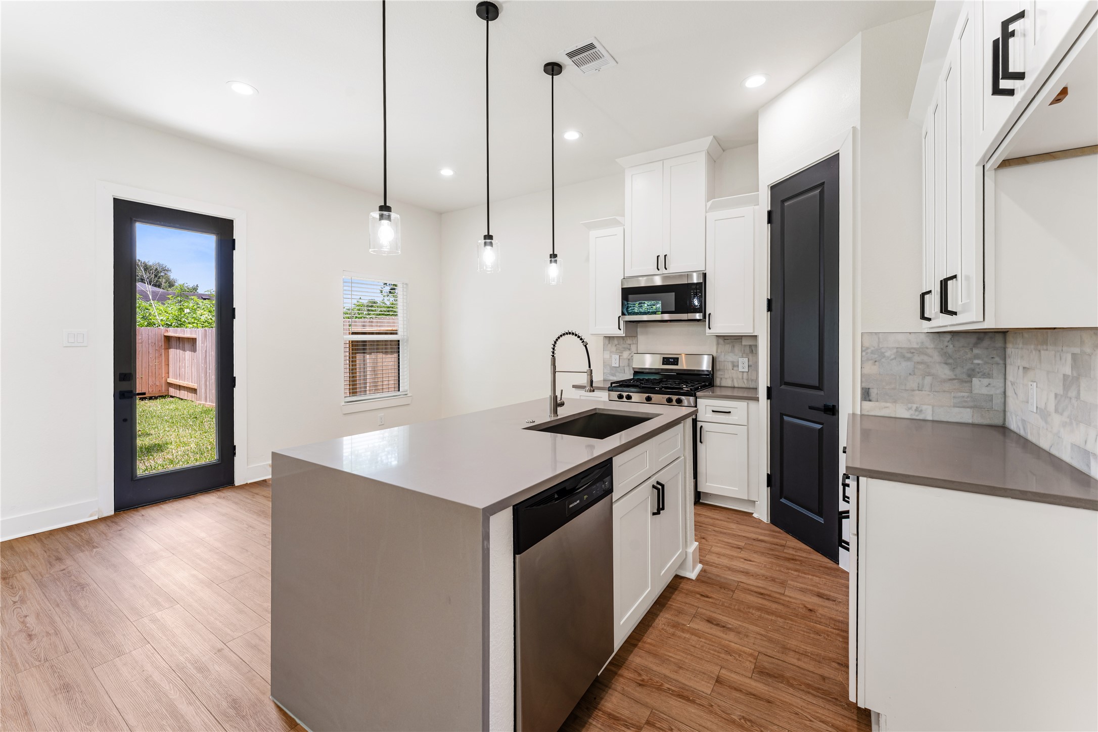 3620 Mt Pleasant Street, Unit A Houston, TX 77021 - Photo 4 of 23 a kitchen with stainless steel appliances granite countertop a sink a stove and a refrigerator