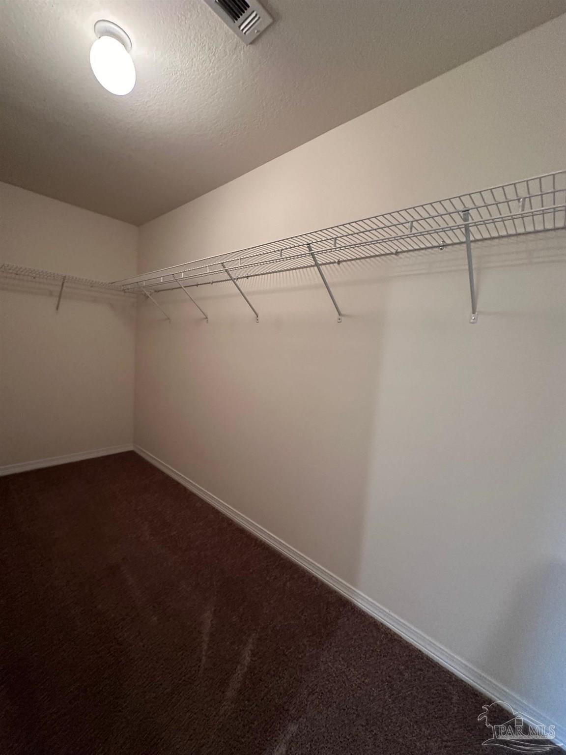 5933 Fairlands Road Milton, FL 32583 - Photo 11 of 16 a view of a room with racks on the wall