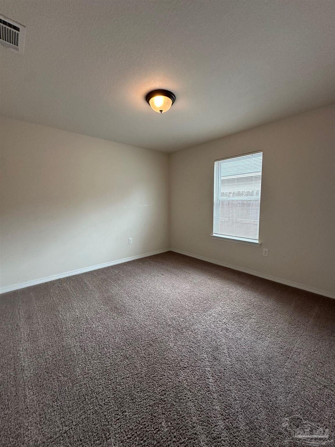 5933 Fairlands Road Milton, FL 32583 - Photo 12 of 16 an empty room with a window