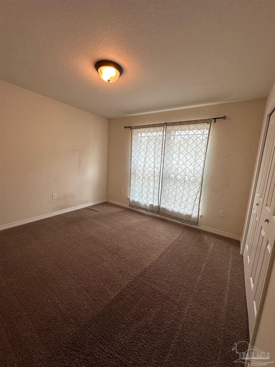 5933 Fairlands Road Milton, FL 32583 - Photo 13 of 16 an empty room with windows