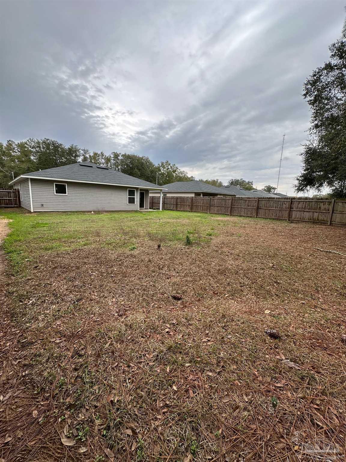 5933 Fairlands Road Milton, FL 32583 - Photo 15 of 16 a view of a big yard with a house