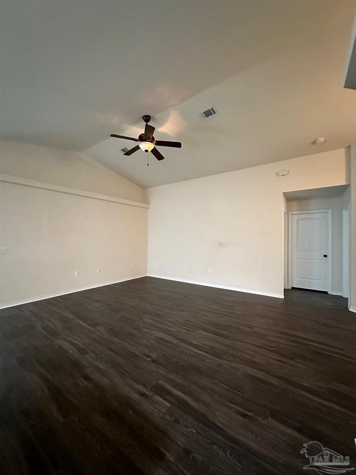 5933 Fairlands Road Milton, FL 32583 - Photo 3 of 16 a view of a livingroom with a ceiling fan and wooden floor