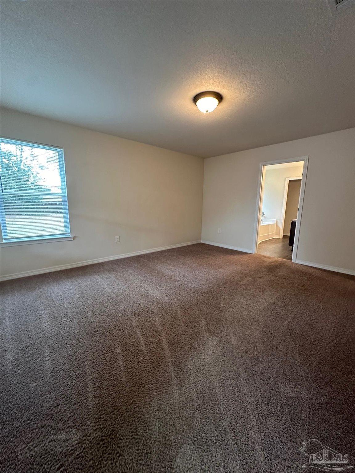 5933 Fairlands Road Milton, FL 32583 - Photo 6 of 16 an empty room with a empty space and windows