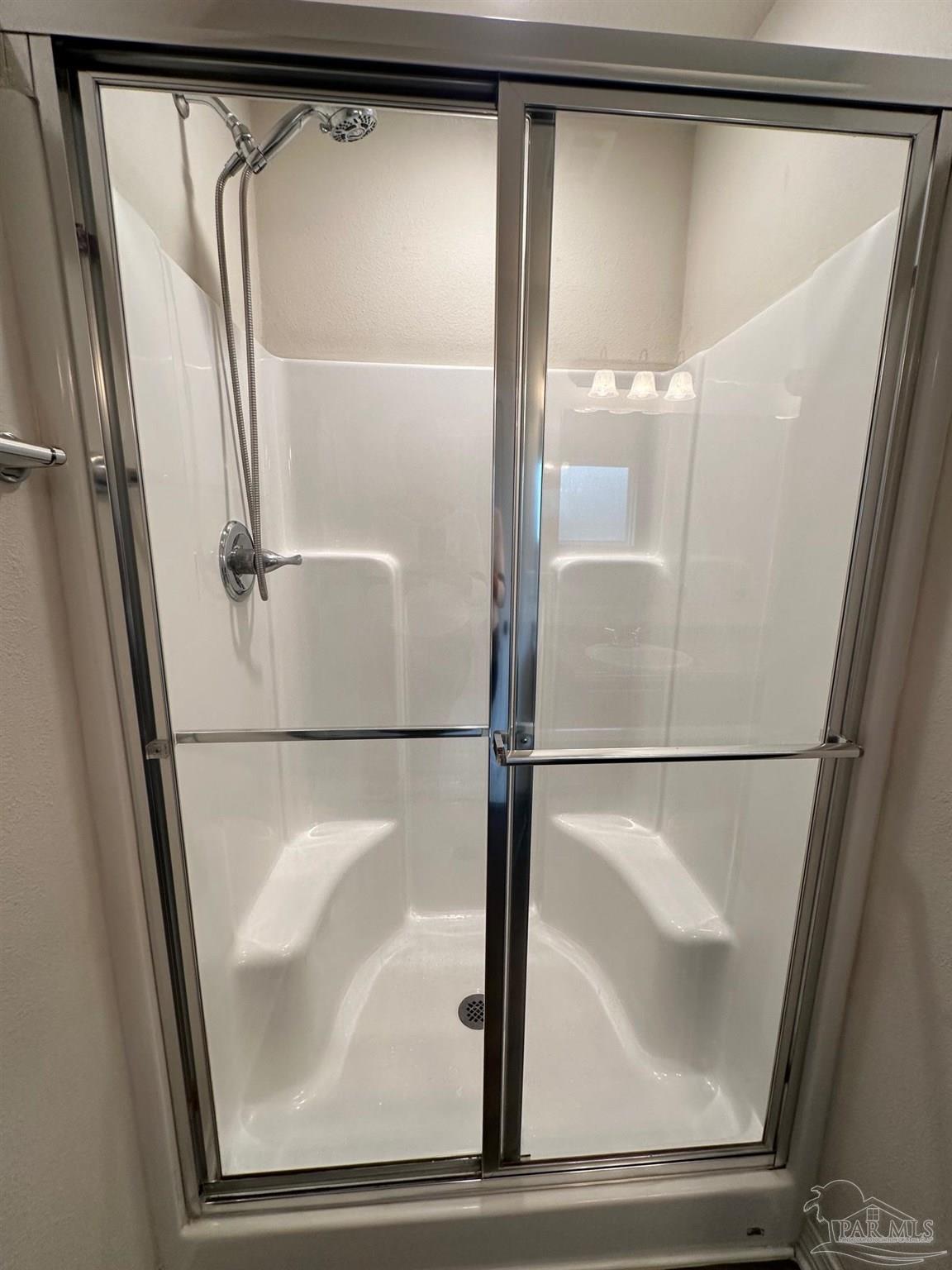 5933 Fairlands Road Milton, FL 32583 - Photo 8 of 16 a bathroom with a glass shower door