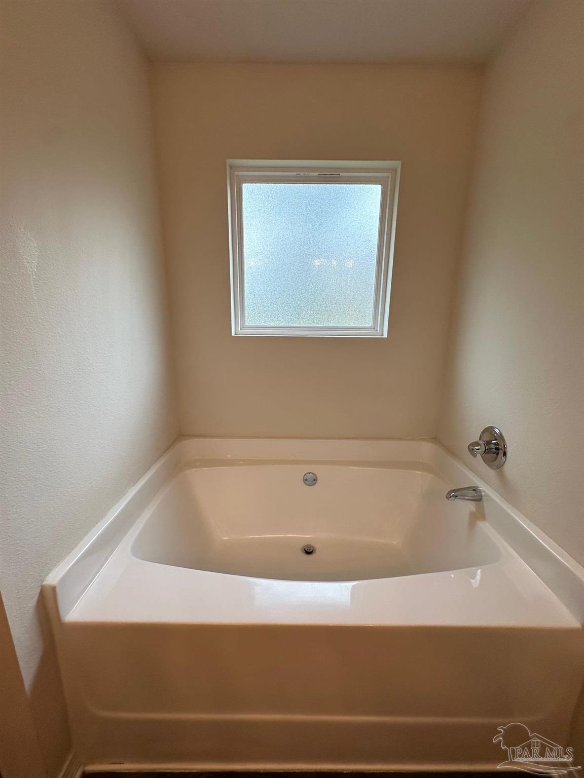 5933 Fairlands Road Milton, FL 32583 - Photo 9 of 16 a bathroom with bathtub