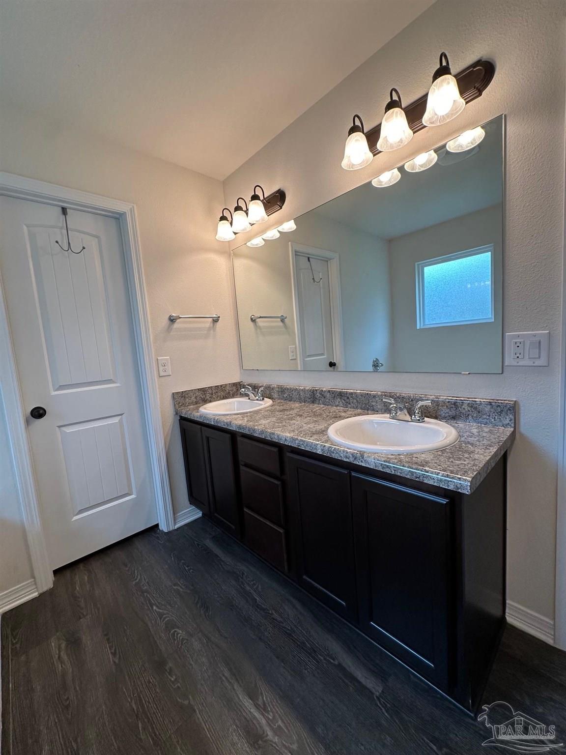 5933 Fairlands Road Milton, FL 32583 - Photo 10 of 16 a bathroom with a sink and a mirror