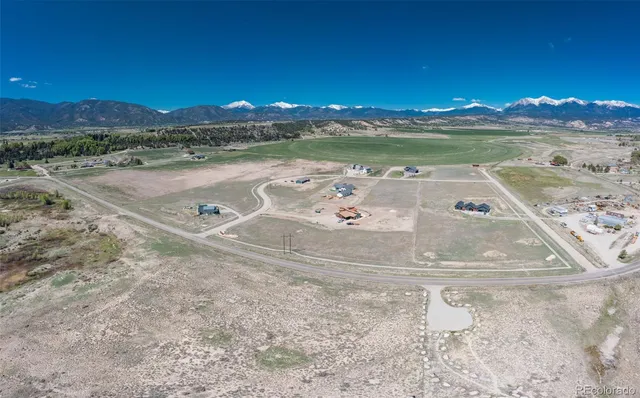 a view of a garden with a bench in the background