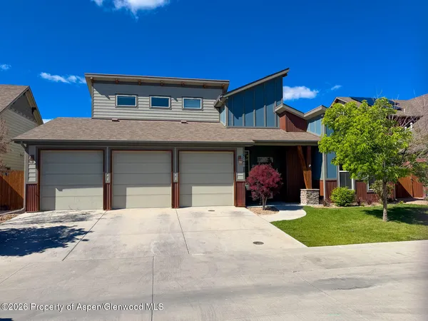 a view of a house with a yard and garage