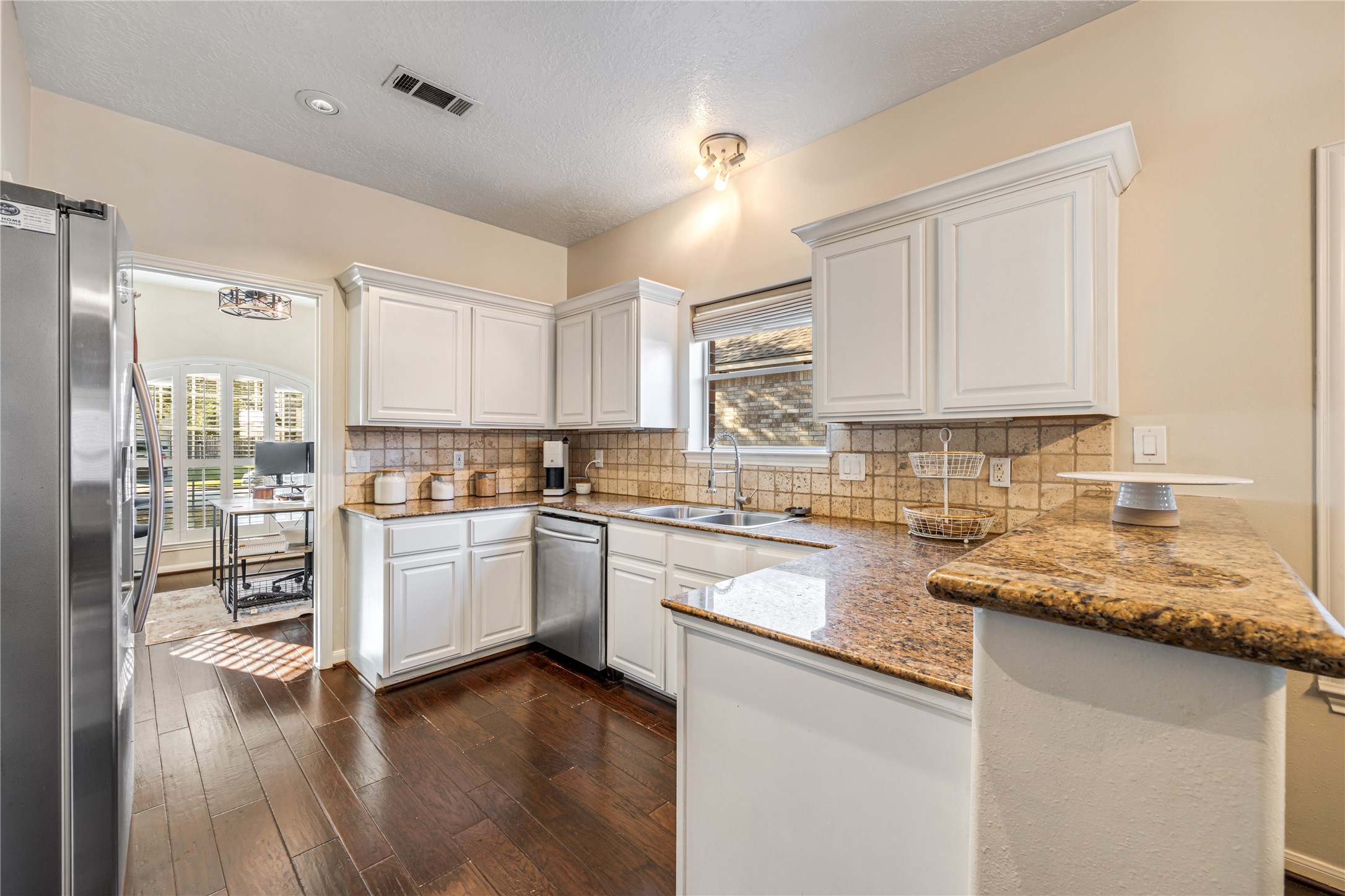23106 Oxbow Trail Spring, TX 77373 - Photo 11 of 43 a kitchen with granite countertop white cabinets and white appliances