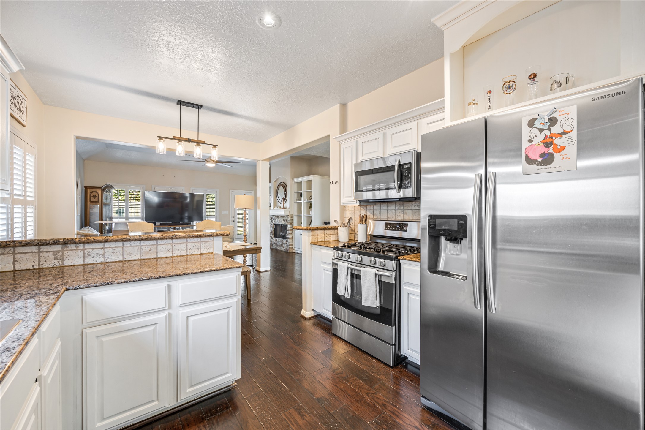 23106 Oxbow Trail Spring, TX 77373 - Photo 13 of 43 a kitchen with white cabinets and stainless steel appliances