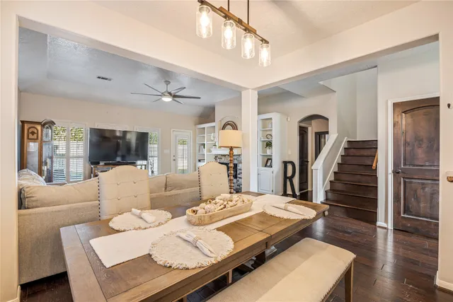 a living room with furniture a clock and a flat screen tv