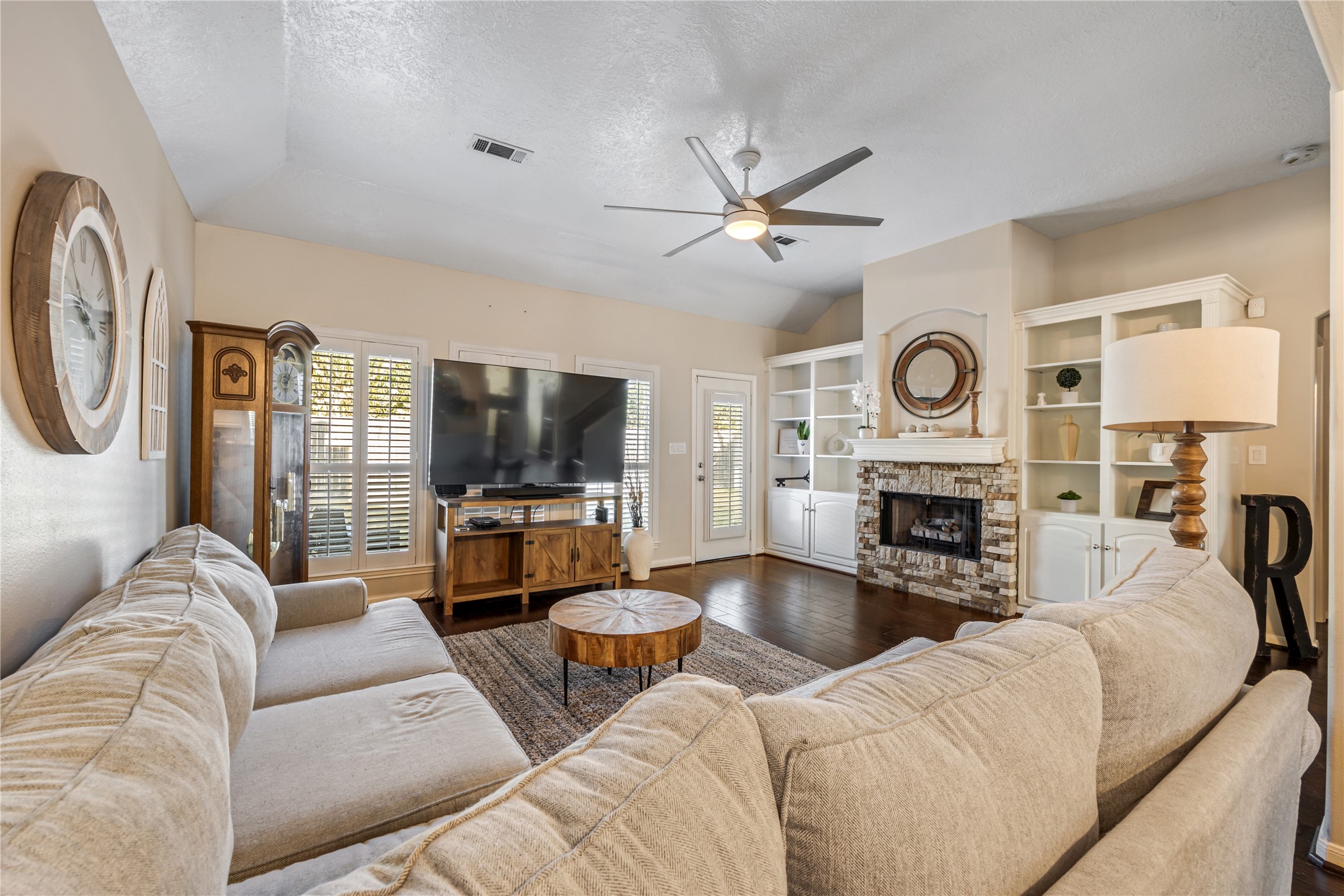 23106 Oxbow Trail Spring, TX 77373 - Photo 18 of 43 a living room with furniture a clock and a flat screen tv