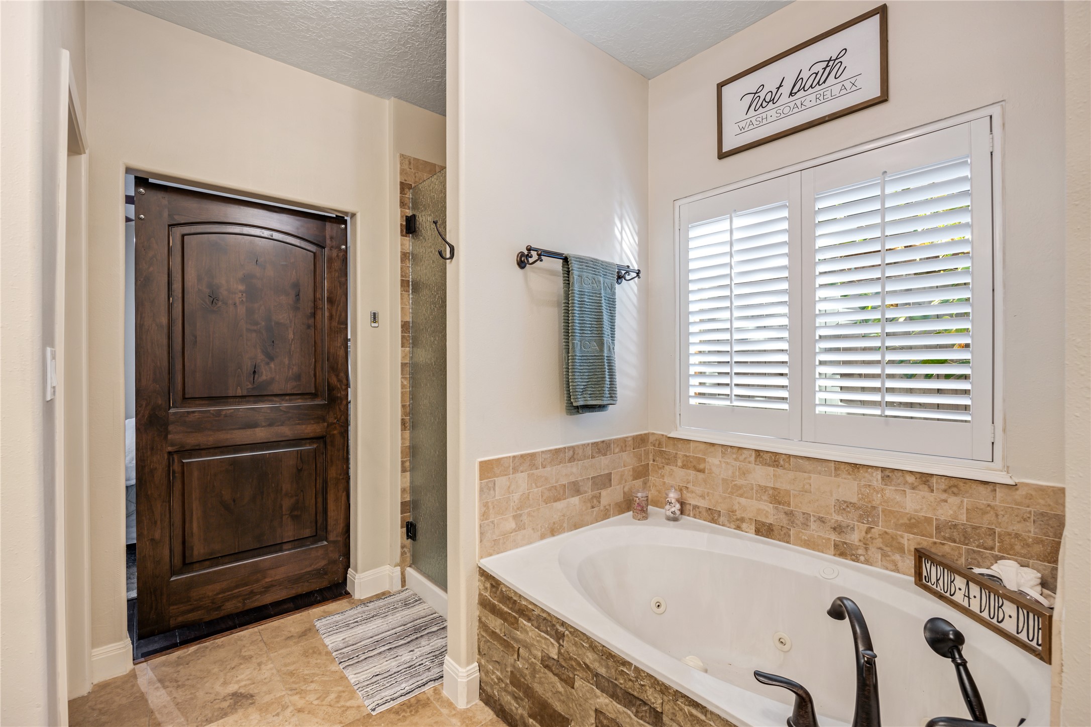 23106 Oxbow Trail Spring, TX 77373 - Photo 26 of 43 a bathroom with a bathtub and a shower