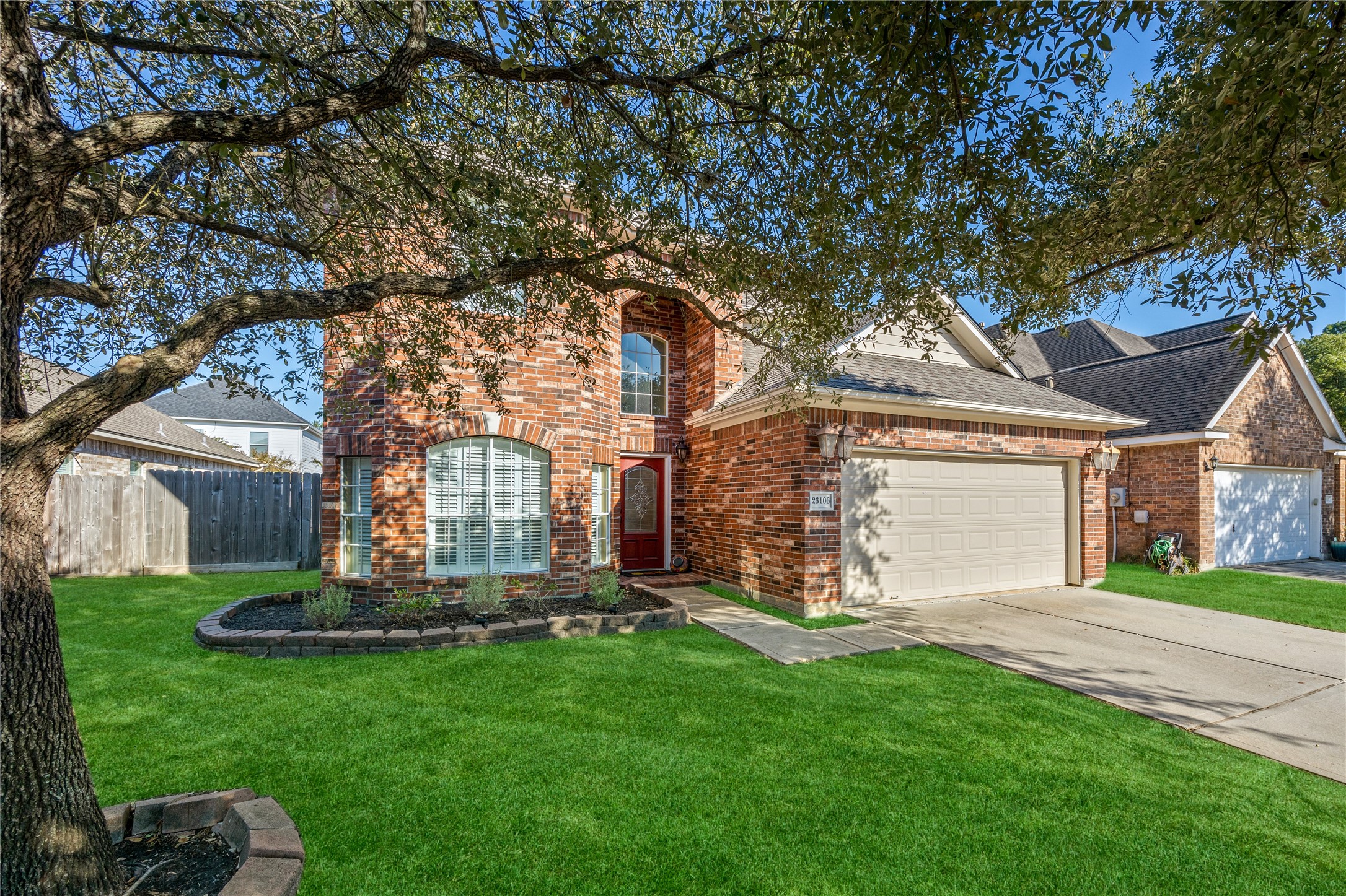 23106 Oxbow Trail Spring, TX 77373 - Photo 3 of 43 a front view of a house with a garden and tree