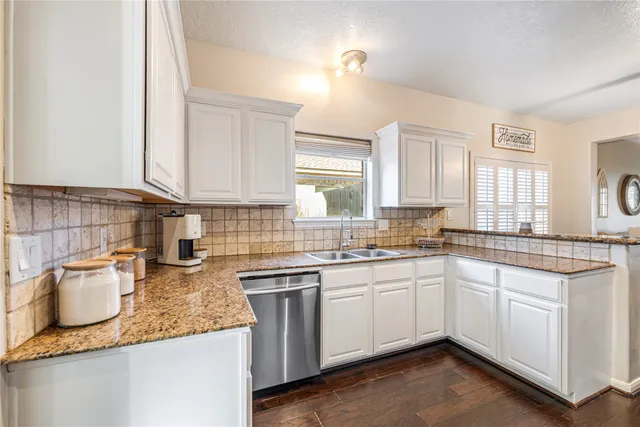 a kitchen with stainless steel appliances granite countertop a refrigerator stove and sink