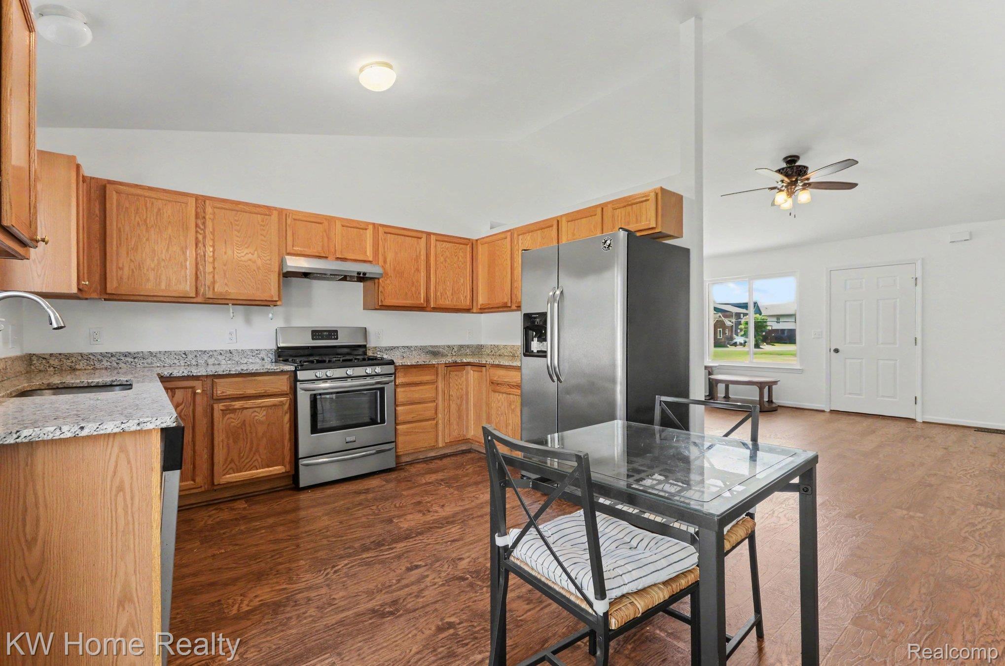 2383 East Maple Road Troy, MI 48083 - Photo 7 of 25 Kitchen featuring wood-finish flooring, light wood cabinetry, stainless steel appliances, and light-toned countertops