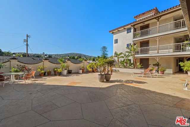 a front view of a building with sitting area