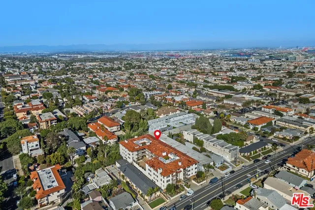 an aerial view of residential houses with city view