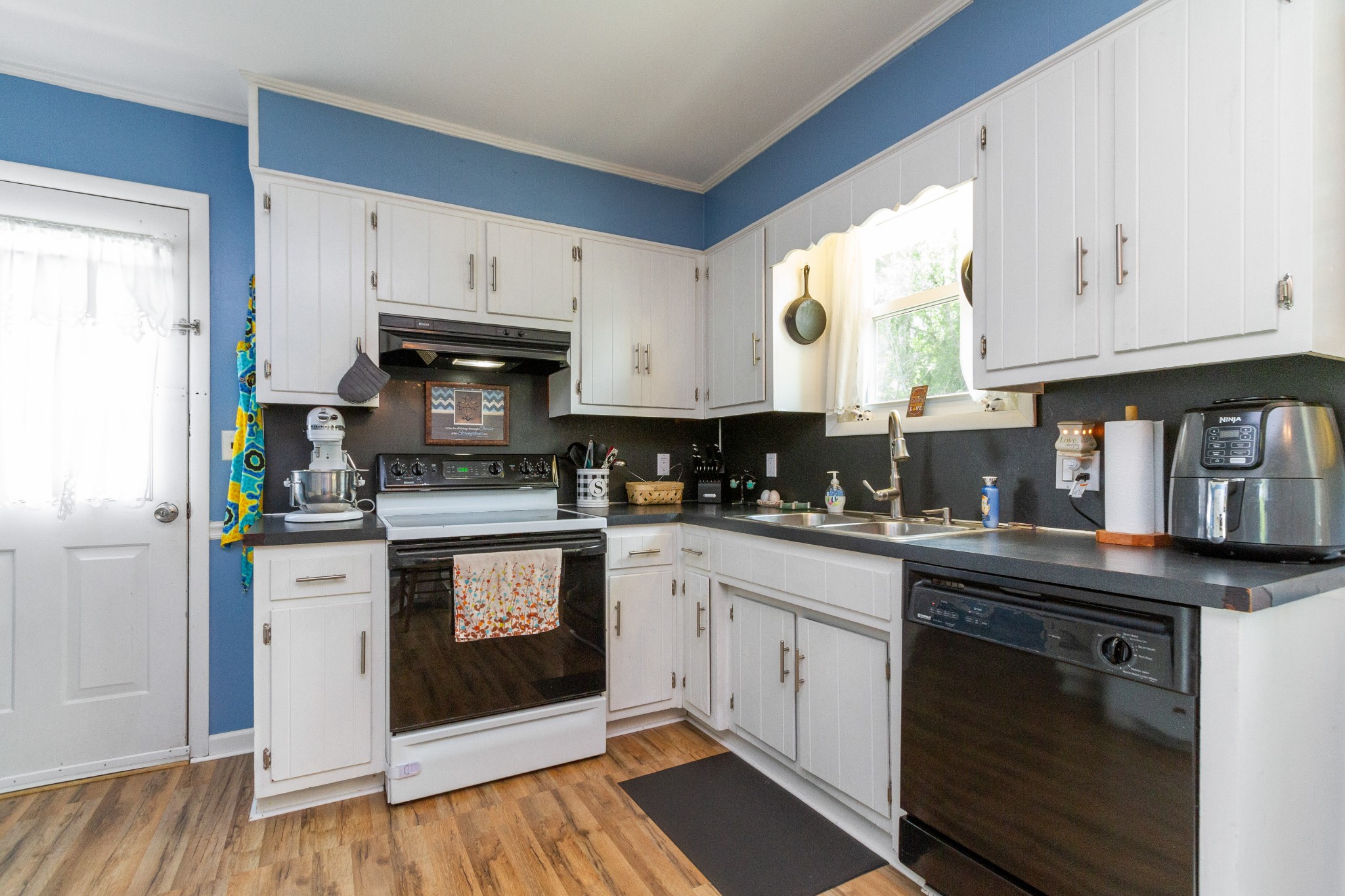 1940 Austin Road Lafayette, TN 37083 - Photo 20 of 41 a kitchen with stainless steel appliances granite countertop a stove a sink and white cabinets