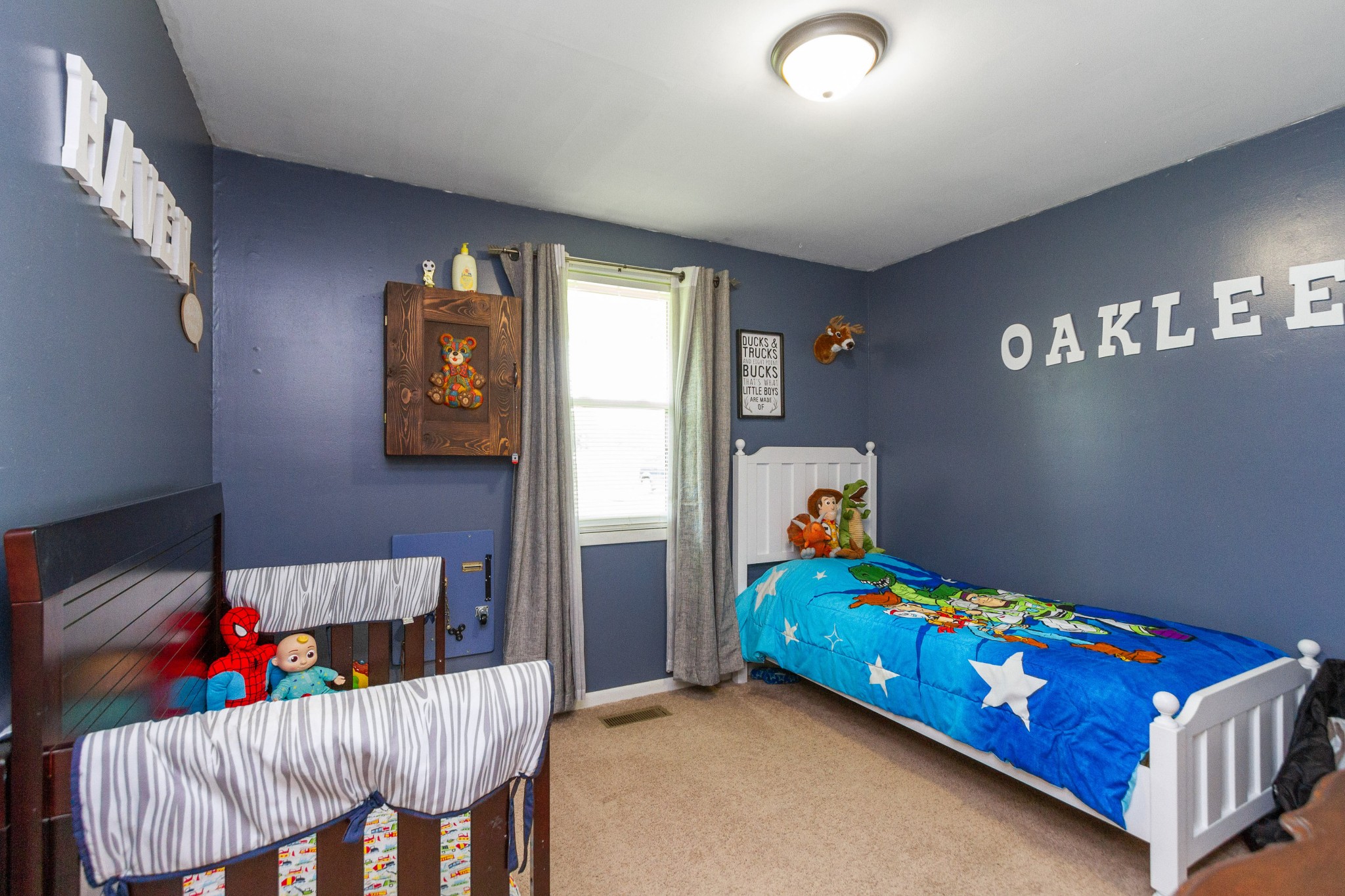 1940 Austin Road Lafayette, TN 37083 - Photo 29 of 41 a bedroom with a bed and a chandelier