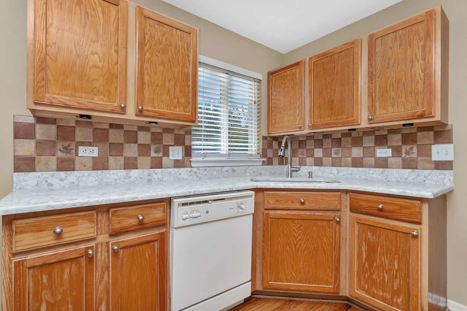 2509 Rosehall Lane Aurora, IL 60503 - Photo 19 of 51 a kitchen with granite countertop cabinets sink and window