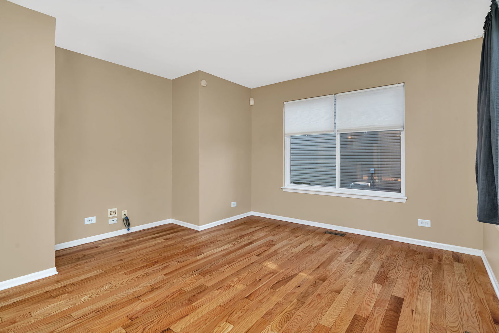 2509 Rosehall Lane Aurora, IL 60503 - Photo 23 of 51 a view of an empty room with wooden floor and a window