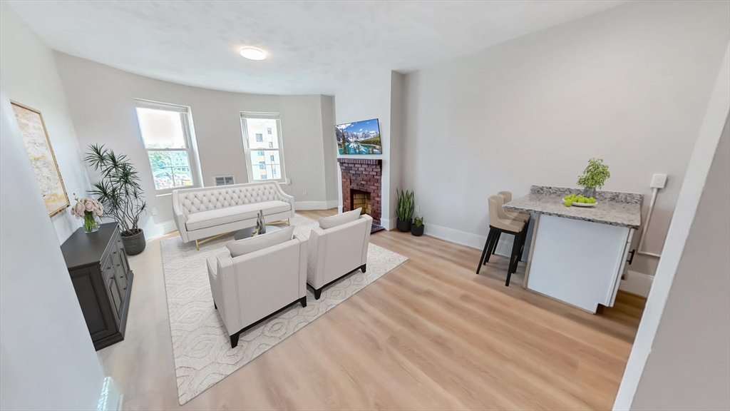 44 Guild Street, Unit 1 Boston, MA 02119 - Photo 3 of 9 a living room with furniture and a wooden floor