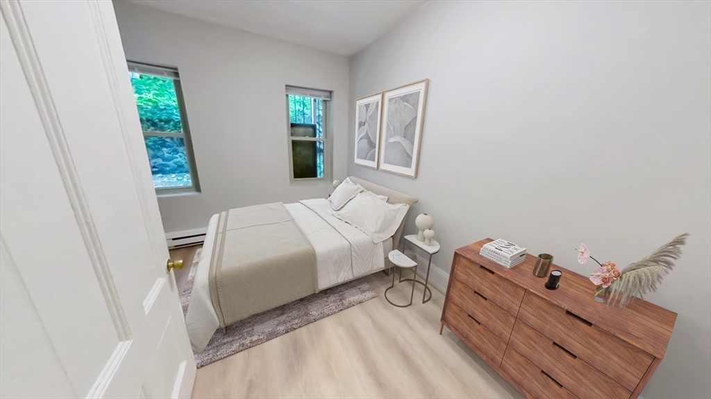 44 Guild Street, Unit 1 Boston, MA 02119 - Photo 4 of 9 a bedroom with a bed and a window
