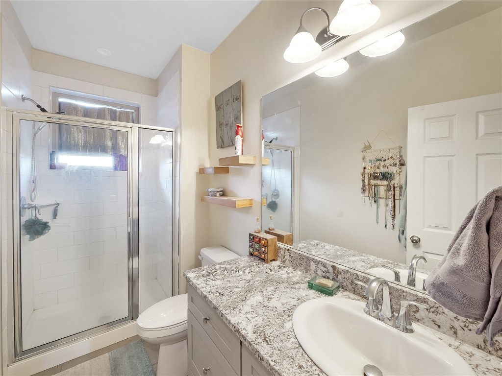 223 Haymaker Street Silverthorne, CO 80498 - Photo 13 of 17 a bathroom with a granite countertop sink a toilet a mirror and shower