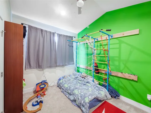 a bedroom with a bed and a baby crib