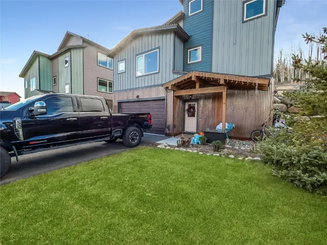 a front view of a house with a garden and plants