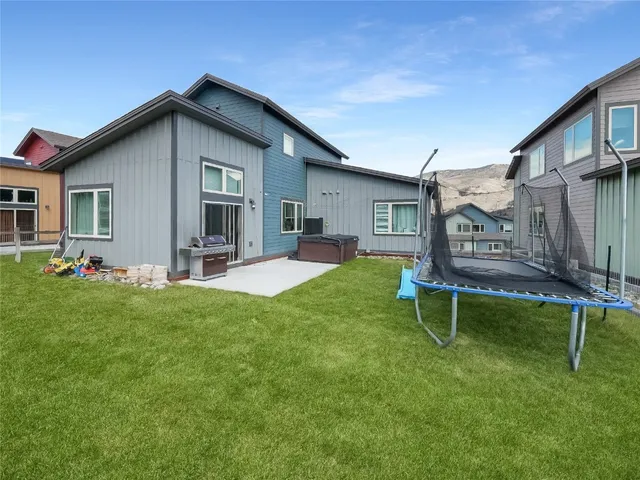 a view of a house with backyard and sitting area