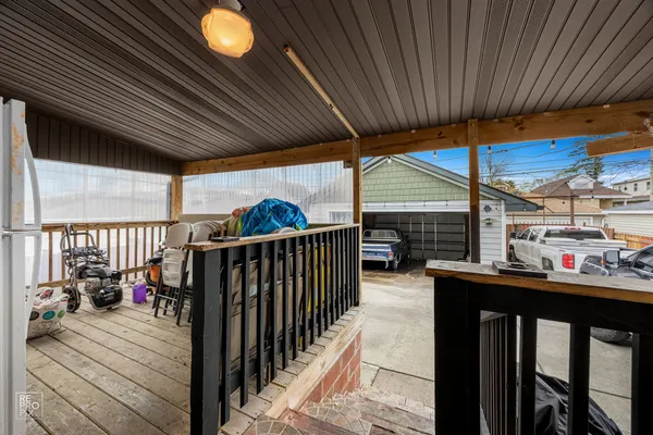 a view of a patio with table and chairs potted plants with wooden floor and fence