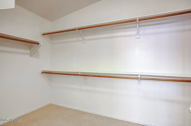 a bathroom with a double vanity sink a large mirror and shower