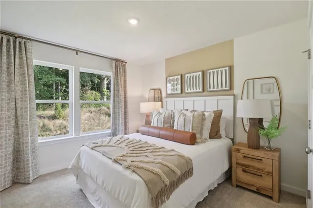 a bedroom with a bed and a lamp