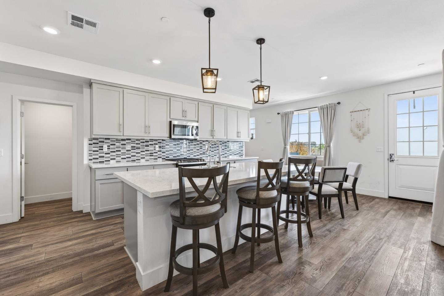 9532 Seawind Way Newark, CA 94560 - Photo 11 of 44 a view of a a dining room with furniture window and wooden floor