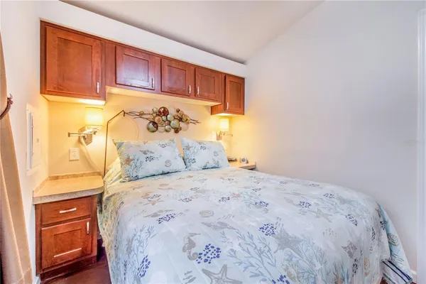 a large bed sitting in a bedroom next to a cabinet