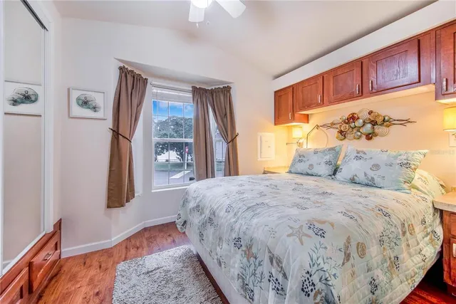 a large bed sitting in a bedroom next to a window