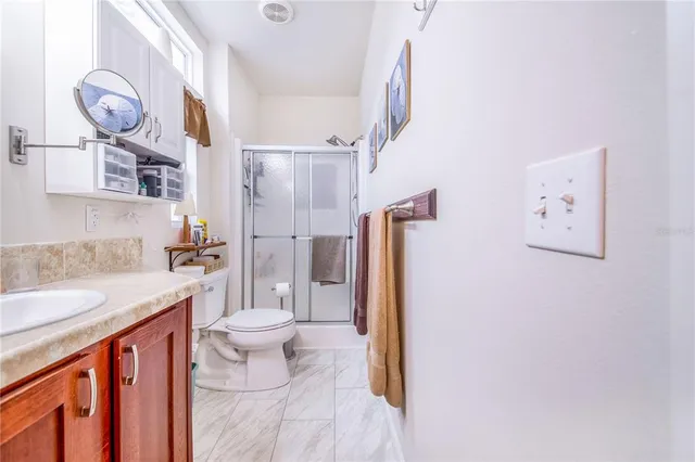 a bathroom with a sink a toilet and a shower