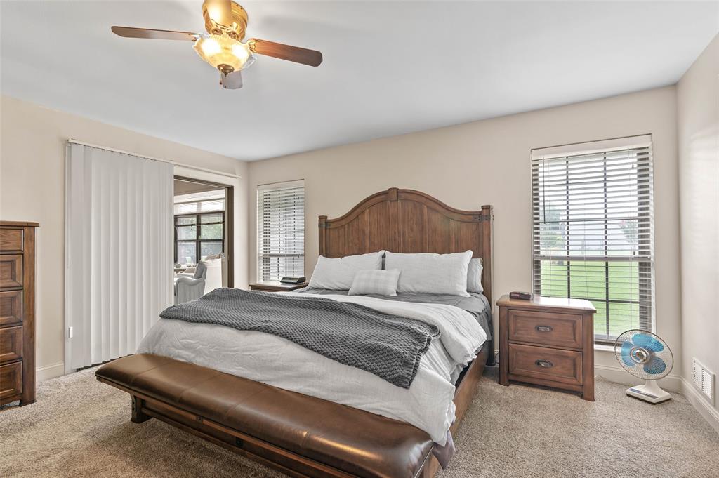 108 Carlin Road Mansfield, TX 76063 - Photo 14 of 40 a bedroom with a bed and a chandelier