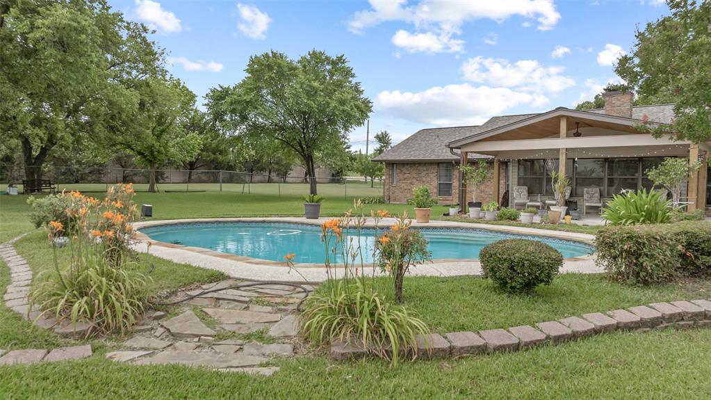 108 Carlin Road Mansfield, TX 76063 - Photo 19 of 40 a swimming pool view with a seating space and a garden